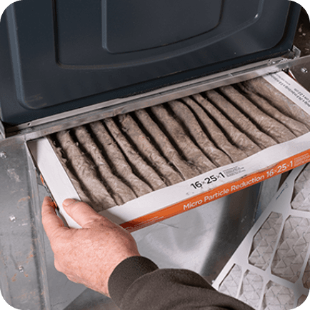 Man holding a dirty air filter