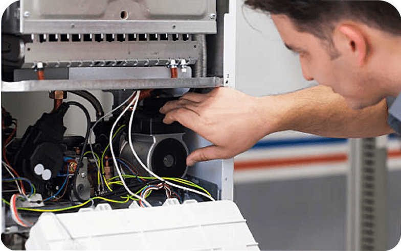 Technician looking at an HVAC system