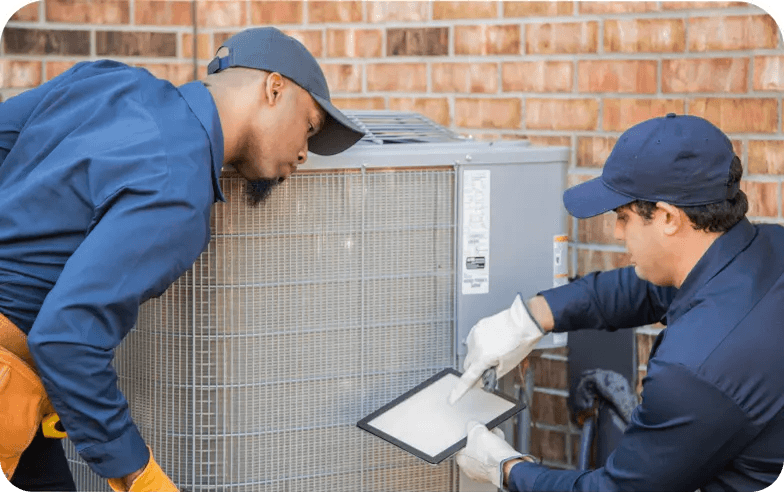 Two techs assessing an HVAC unit